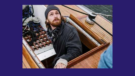 Man in boat wearing a beanie hat 