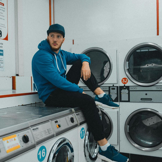 Man in dark blue cap in launderette 