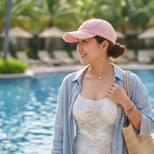 Woman in pink baseball cap by pool 