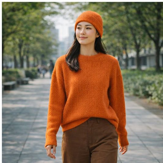 Woman in orange fitted beanie and jumper