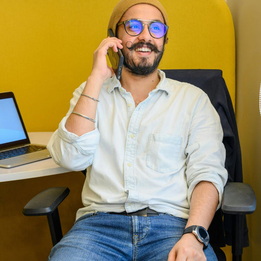 Modern looking man in beige beanie and jeans