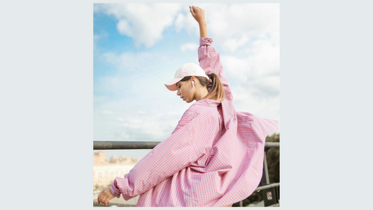 Woman in pink shirt cap and airpods