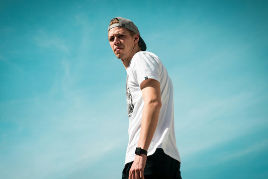 Man in cap back to front and white tee